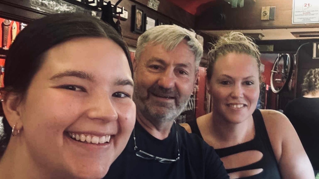 Robbie Wolfe taking a selfie with two members of the Finn’s team